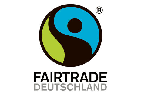 Logo mit Yin Yang-Motiv in den Farben grün, schwarz und blau und Schriftzug Fairtrade Deutschland