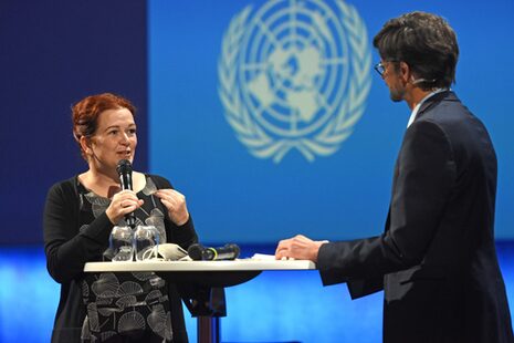 Mayor Katja Dörner with a microphone in her hand talking to a man