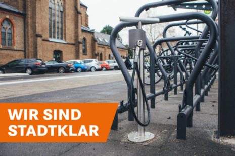 A covered bike station with bike racks and an air pump