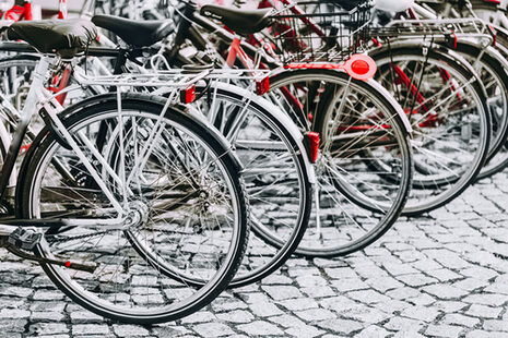 Many bicycles parked in a row